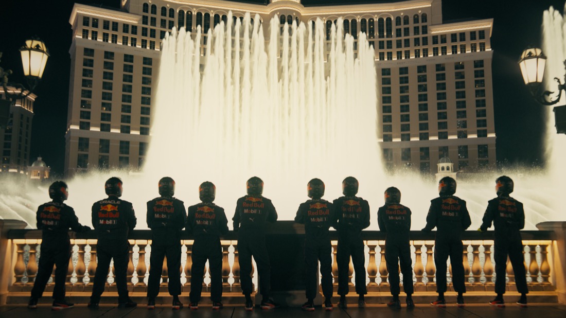 A group of people in uniform standing in front of a fountain