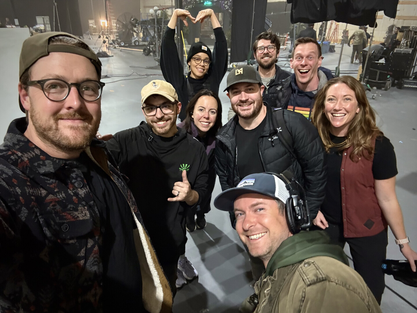 Nine members of the production crew posing for a group photo