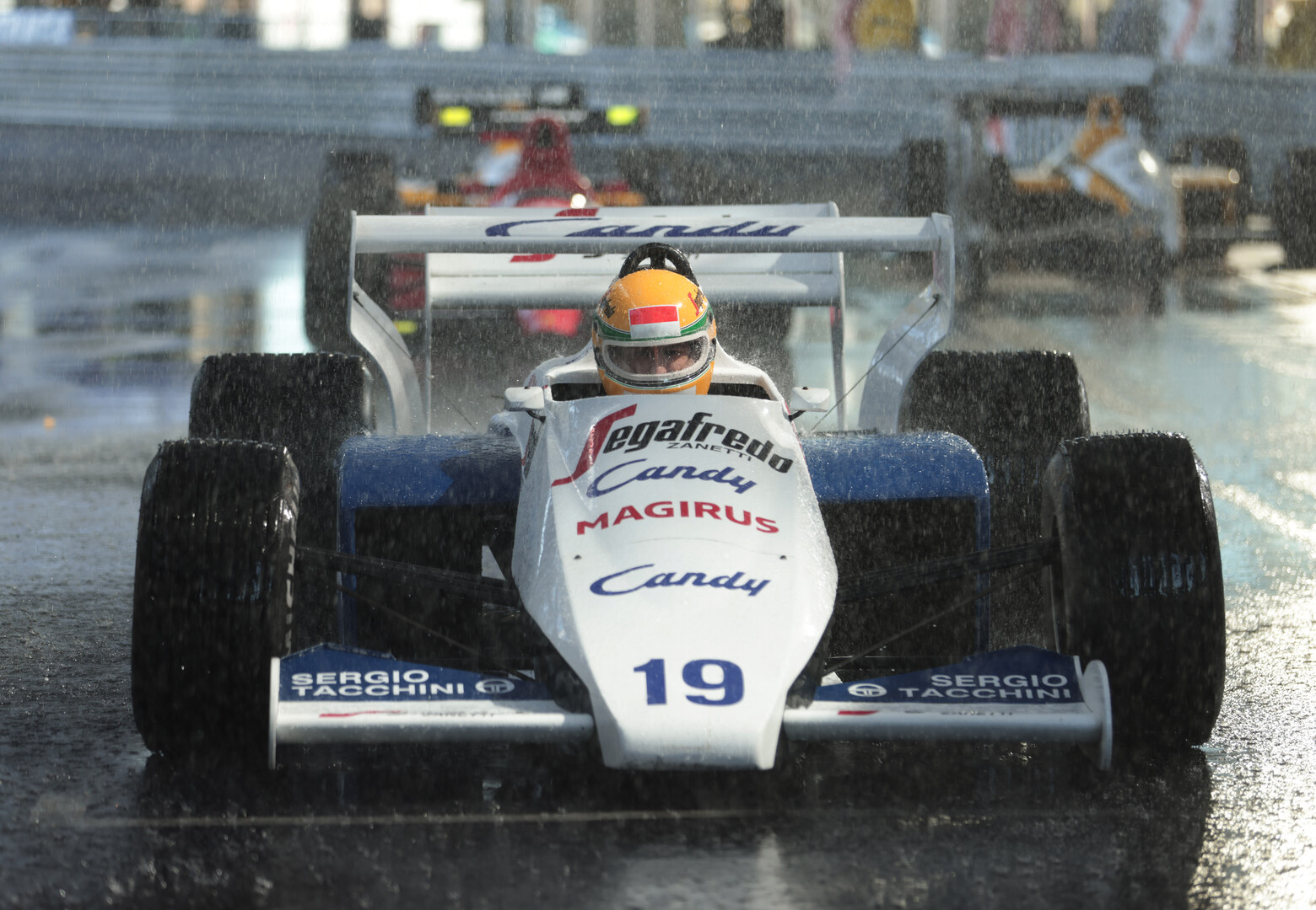 formula 1 cars in the rain at the starting line