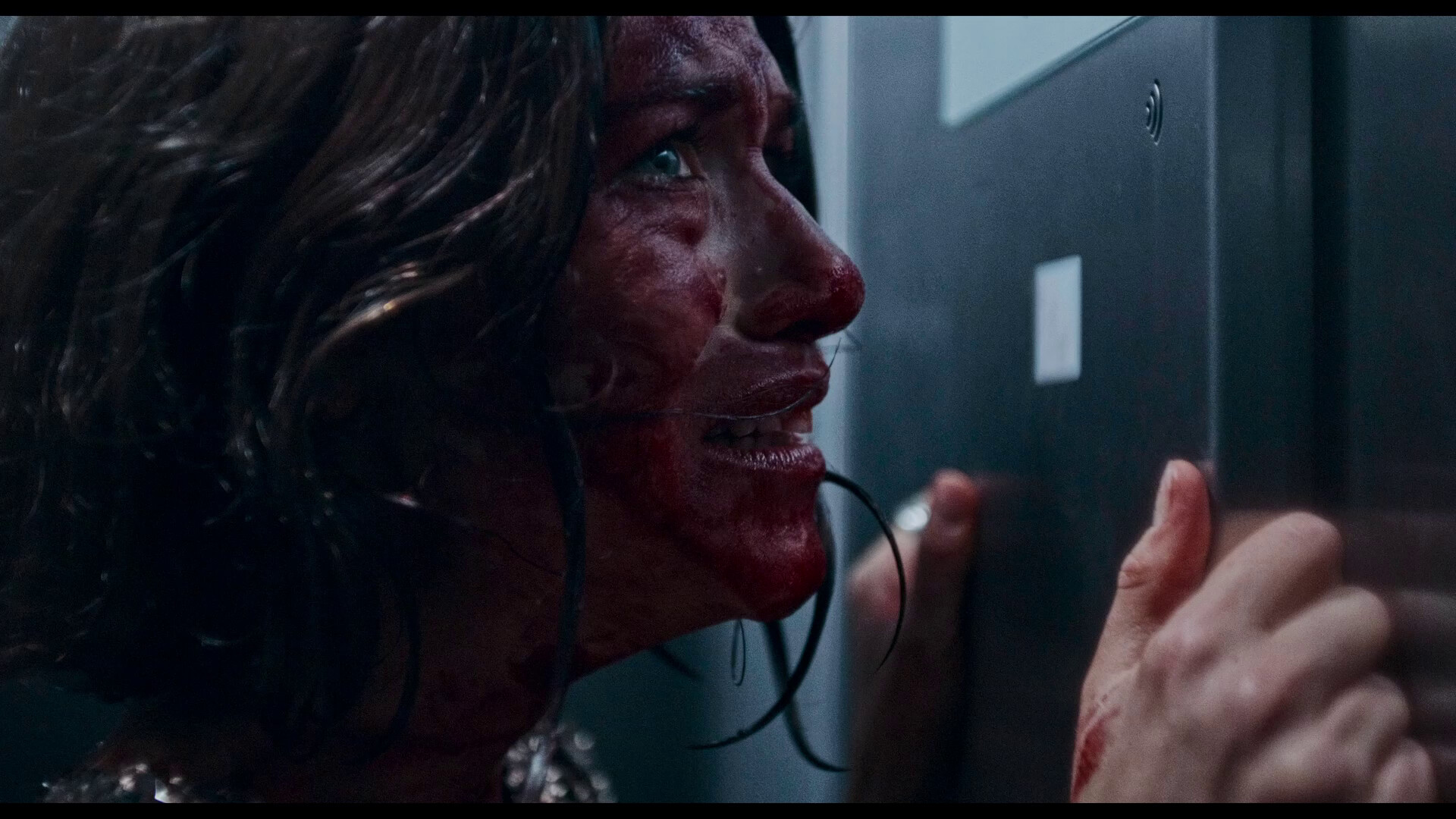 A terrified girl with blood on her face