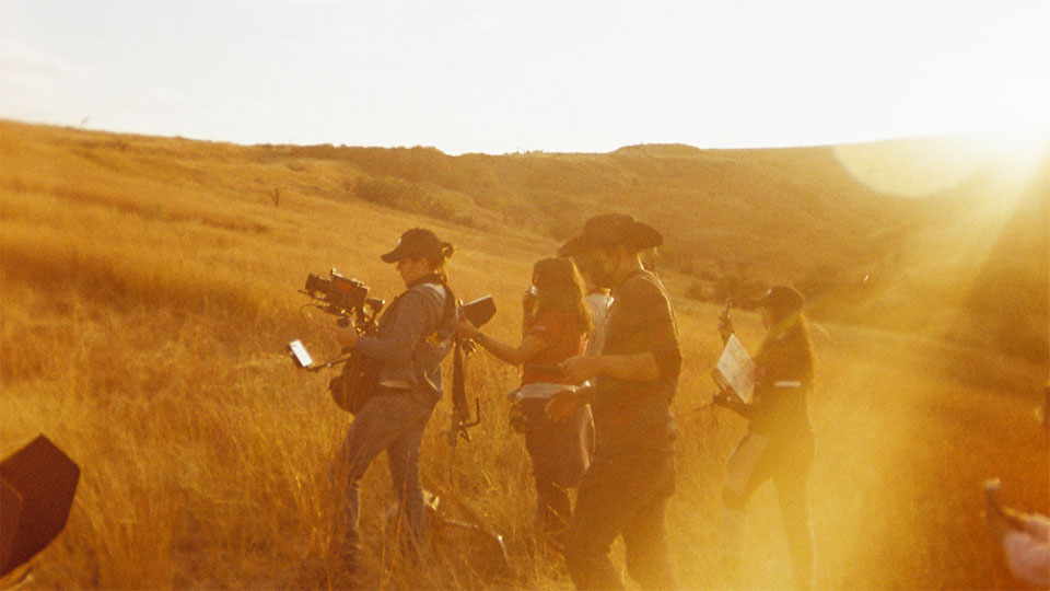 Film crew outdoors at sunset