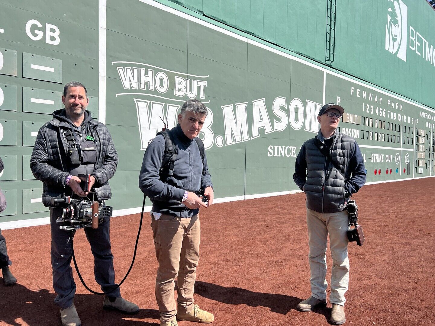 Henry Braham and crew in front of Fenway Park scoreboard