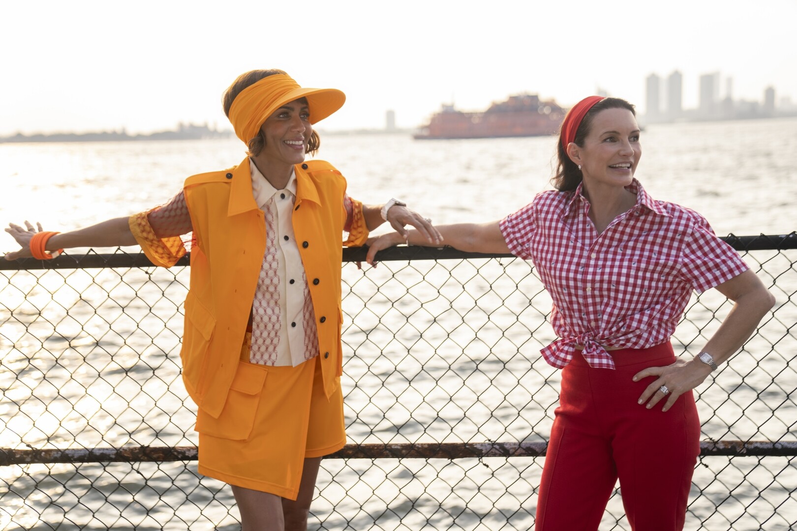 Nicole Ari Parker and Kristin Davis with a city skyline and water in the background