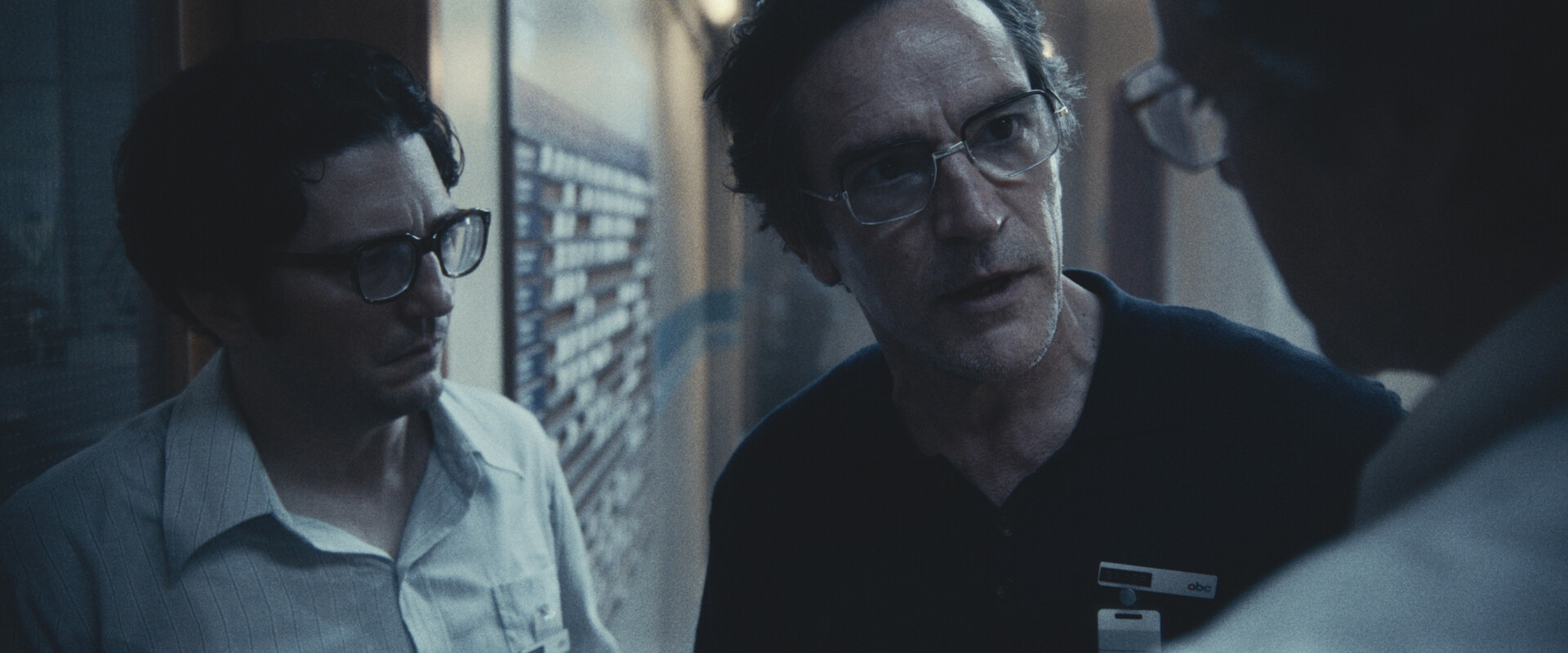 three men with glasses talking