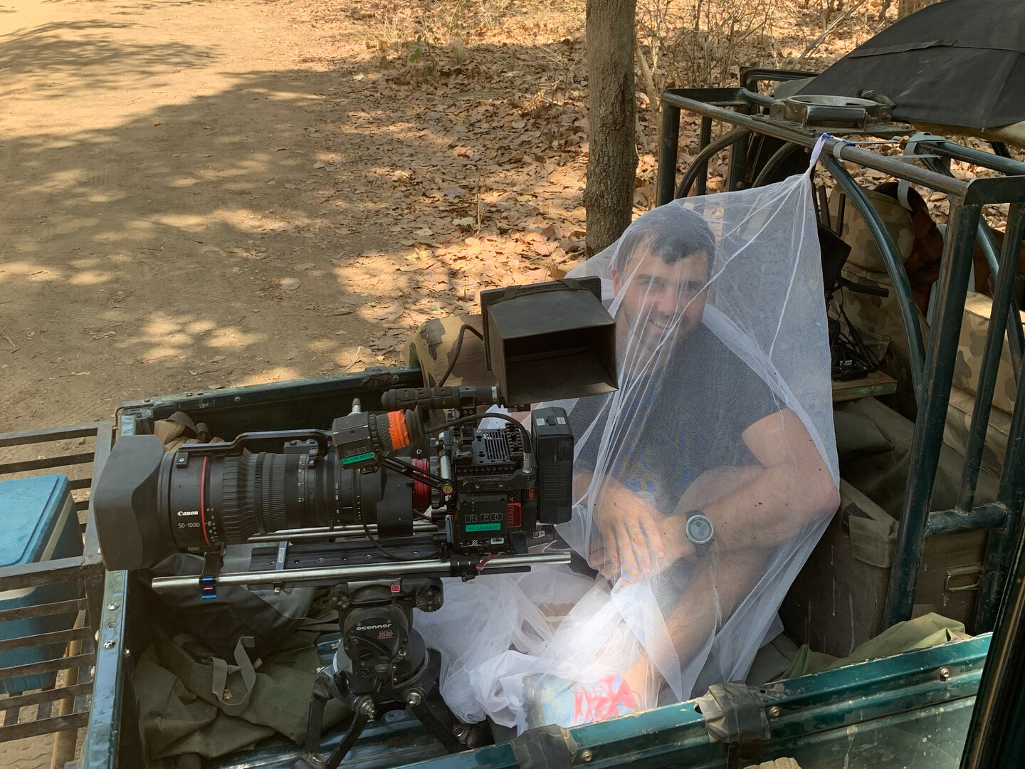 Cameraman inside mosquito net