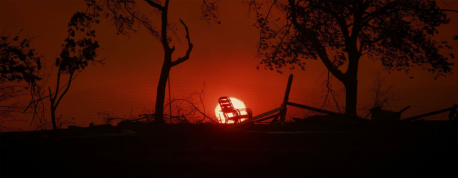 Silhouette of a chair in front of a sunset